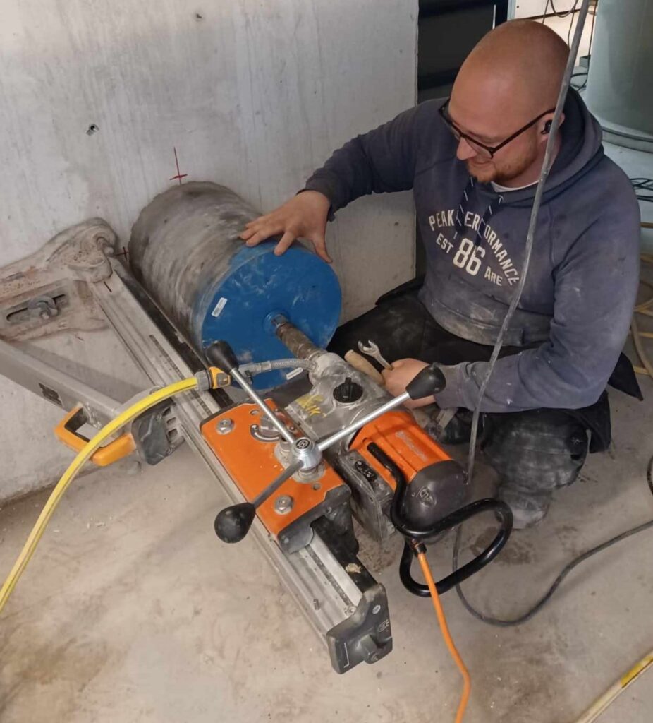 Mand borer i beton med kerneboremaskine